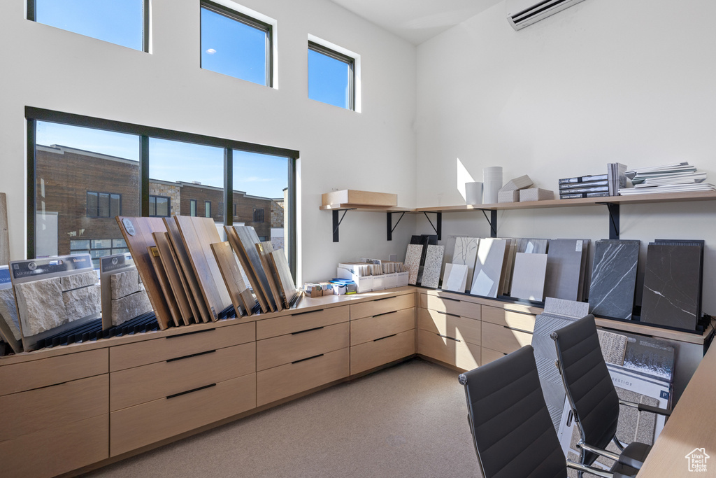 Office space featuring a wall mounted air conditioner and carpet