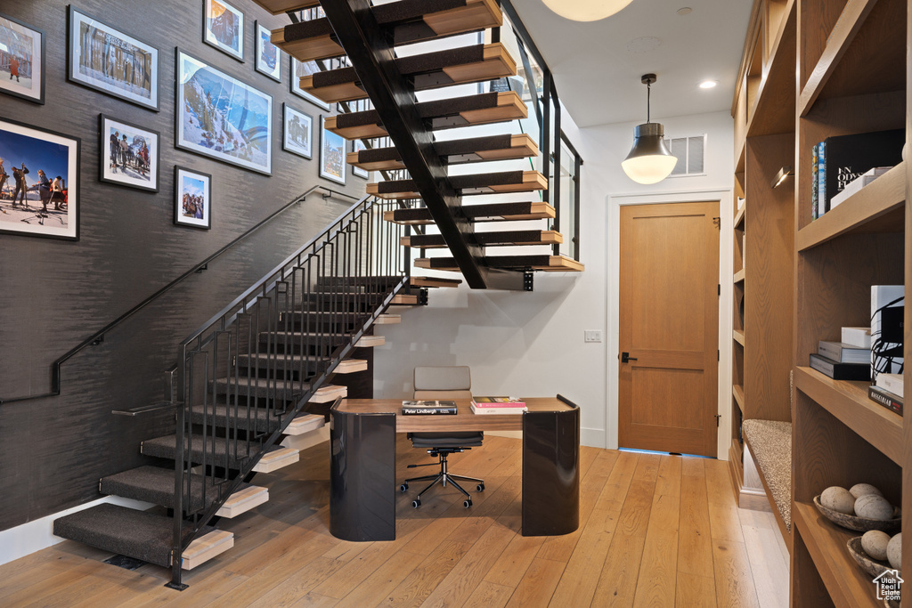 Staircase with baseboards, hardwood / wood-style flooring, visible vents, and recessed lighting