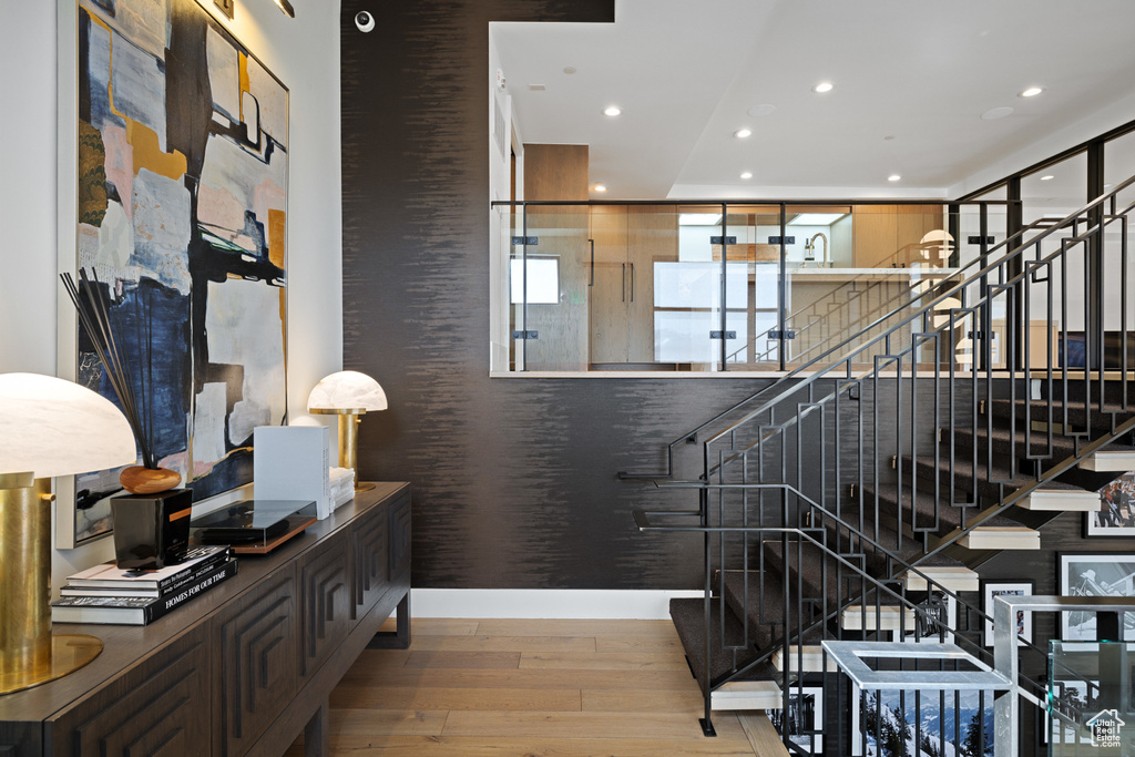Stairs featuring recessed lighting and wood-type flooring