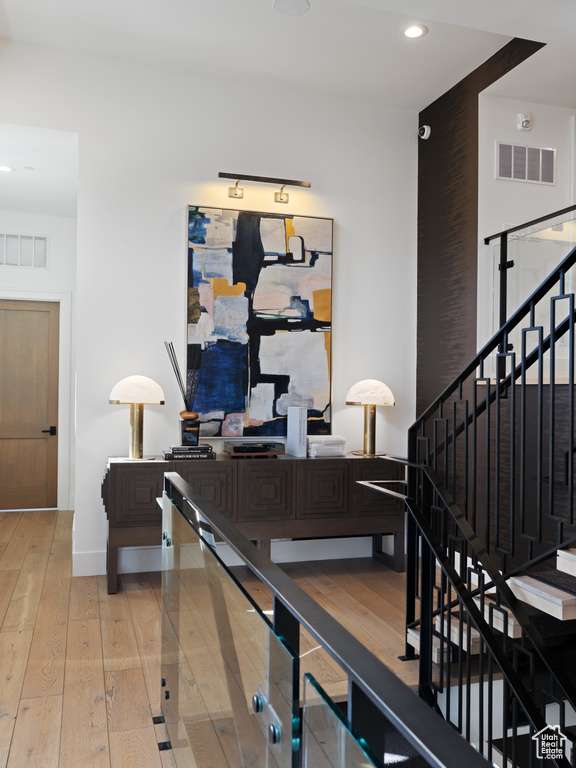 Interior space with baseboards, hardwood / wood-style flooring, visible vents, and recessed lighting