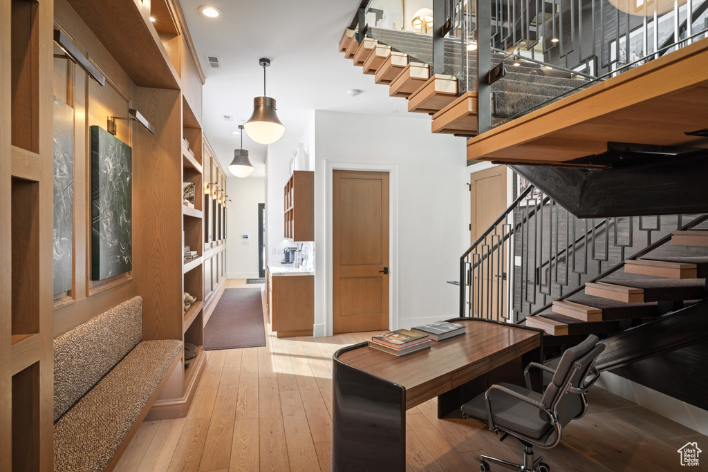 Office area with visible vents, light wood-style flooring, baseboards, and recessed lighting