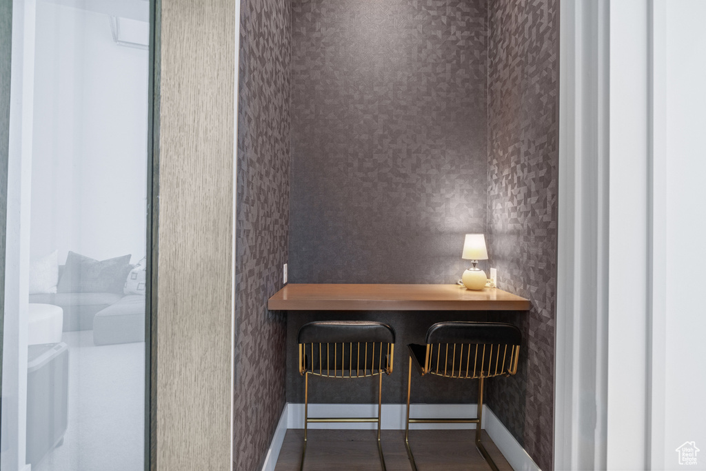 Dining area with wallpapered walls and baseboards