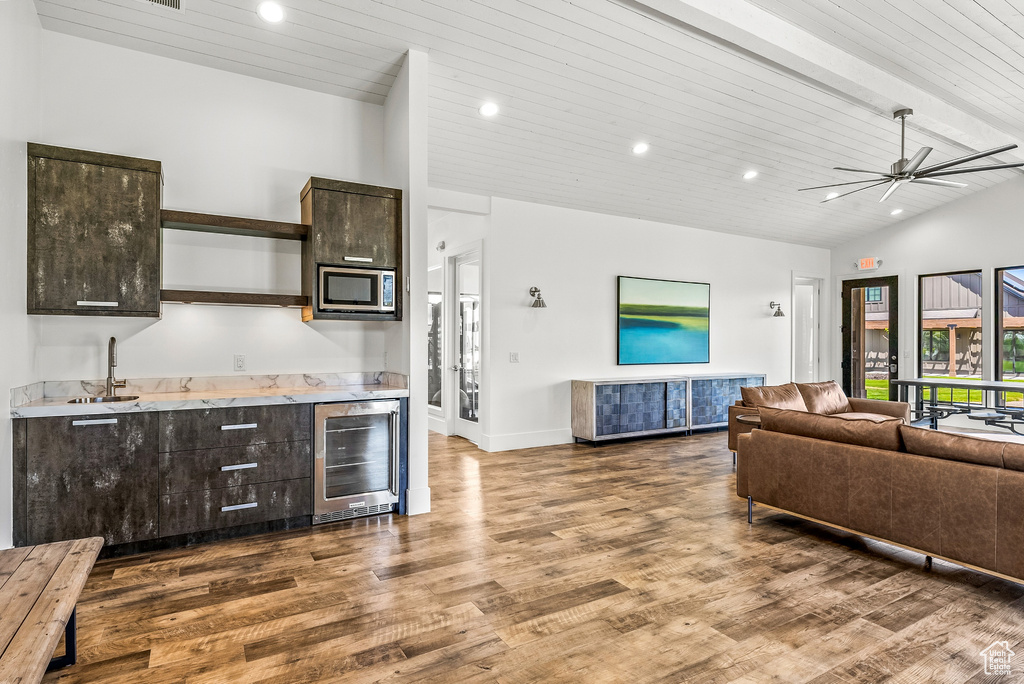 Living area with wood finished floors, wooden ceiling, beverage cooler, bar area, and recessed lighting