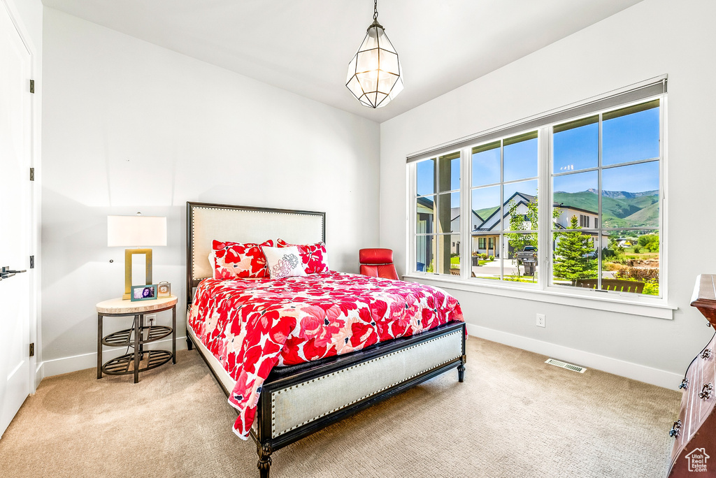 Carpeted bedroom with baseboards and visible vents