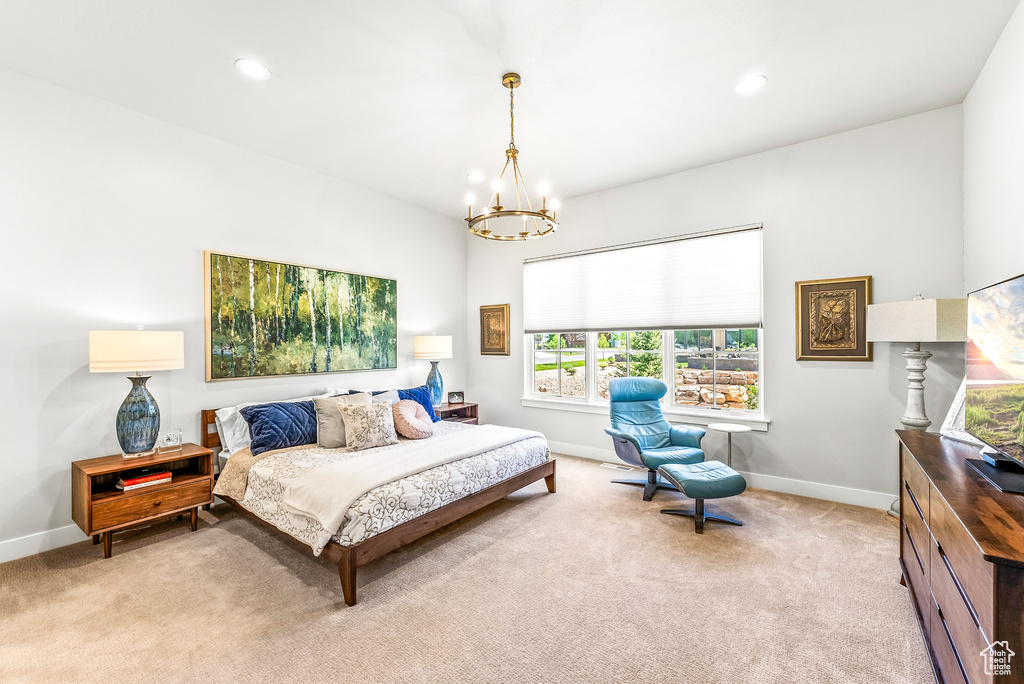 Carpeted bedroom featuring baseboards, recessed lighting, and a notable chandelier