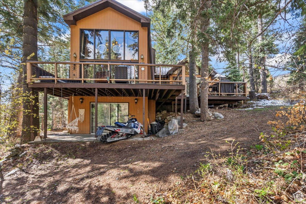 Rear view of house featuring a wooden deck