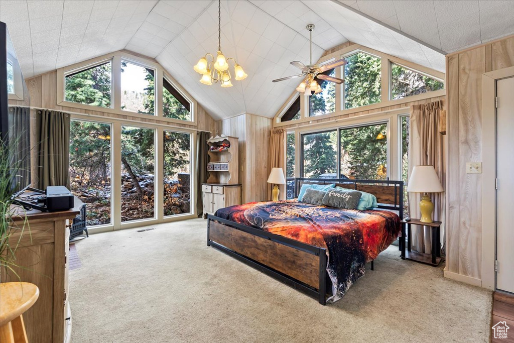 Bedroom featuring carpet floors, wood walls, and lofted ceiling