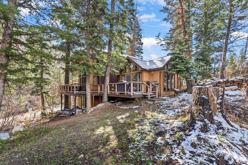 Exterior space with a wooden deck and metal roof