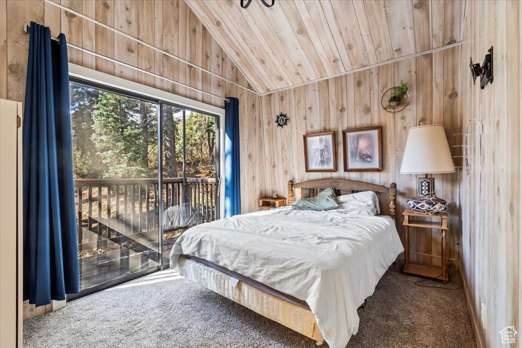 Carpeted bedroom with access to outside, wood ceiling, lofted ceiling, and wooden walls