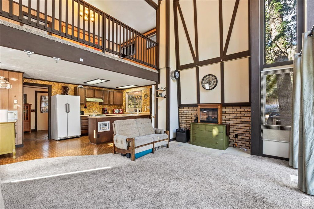Living room with a high ceiling and carpet flooring