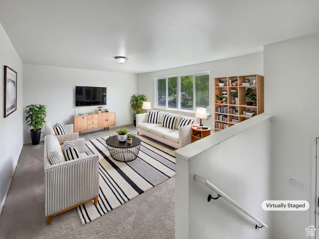 Carpeted living room featuring baseboards
