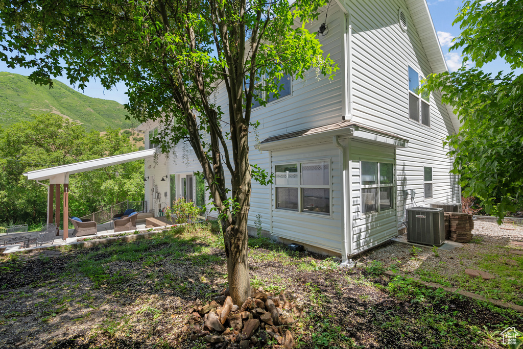 View of side of property featuring a patio area and a mountain view