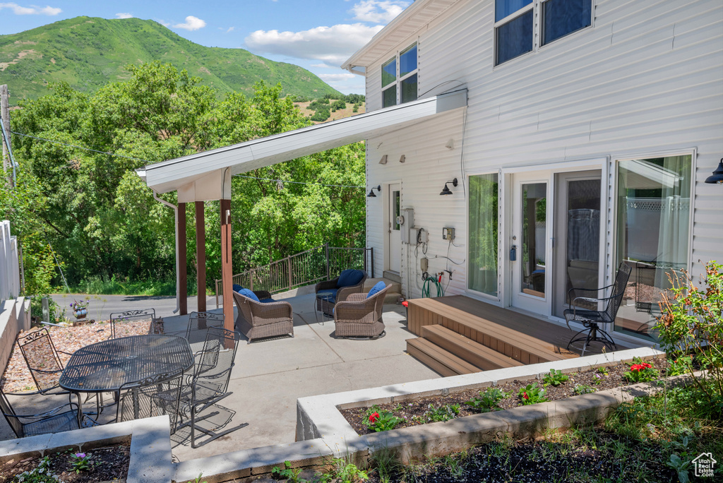 View of patio featuring outdoor lounge area, a mountain view, and outdoor dining space