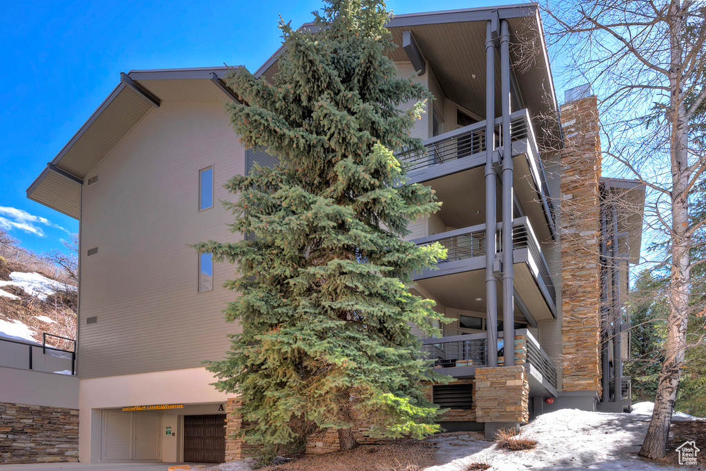 View of home\\\'s exterior featuring stairs and a garage