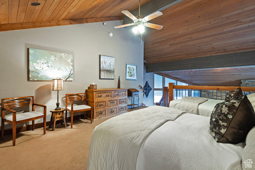 Carpeted bedroom with lofted ceiling, a ceiling fan, and wooden ceiling