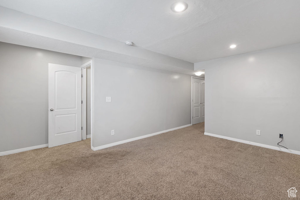 Below grade area with baseboards, recessed lighting, and carpet