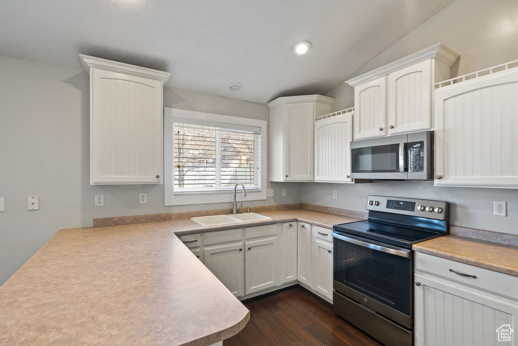 Kitchen featuring light countertops, appliances with stainless steel finishes, and a sink