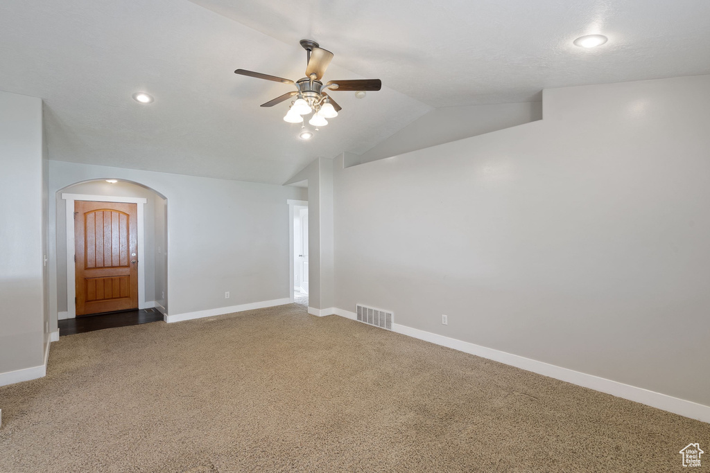 Spare room with recessed lighting, visible vents, arched walkways, carpet flooring, and ceiling fan