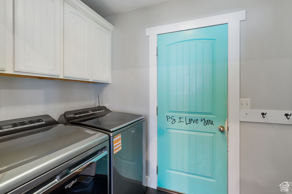 Washroom with cabinet space and independent washer and dryer