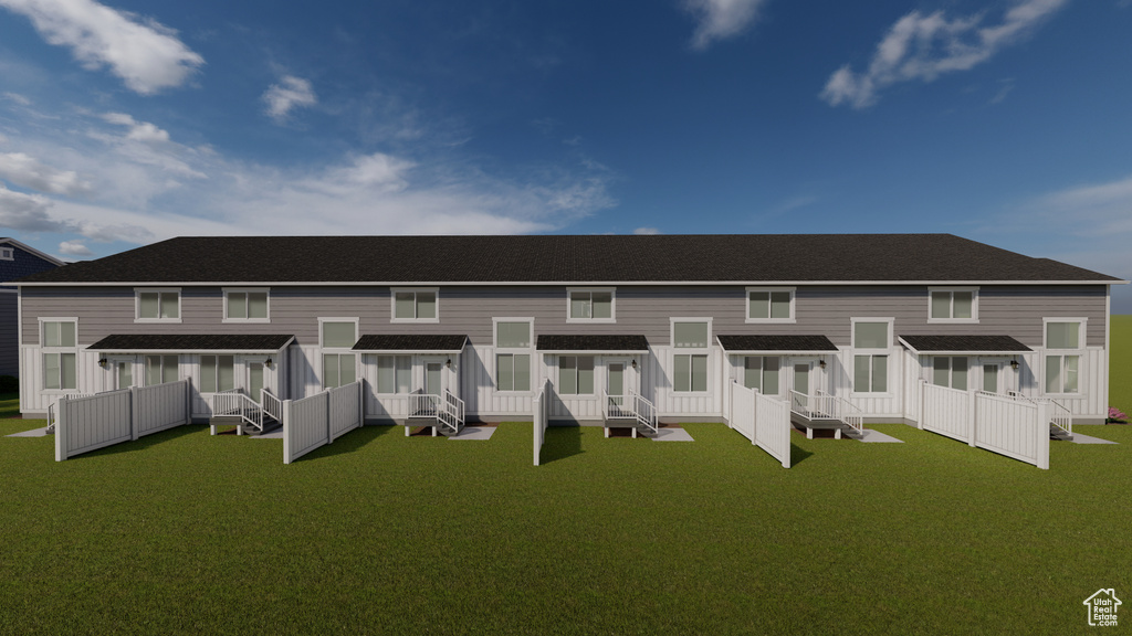 Rear view of property featuring a yard
