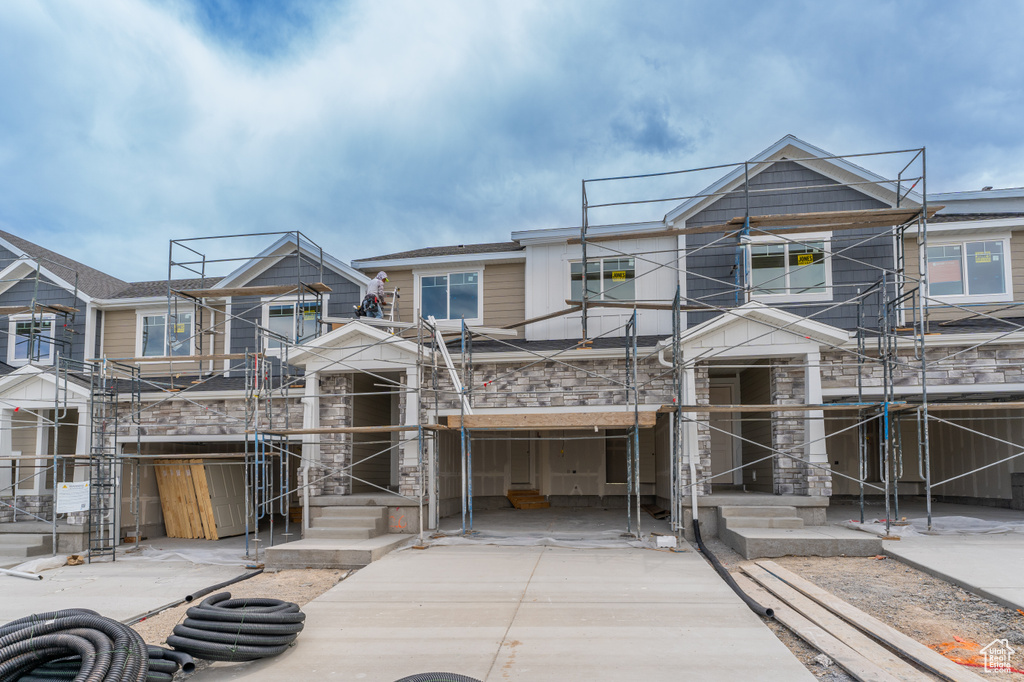 Unfinished property featuring stone siding