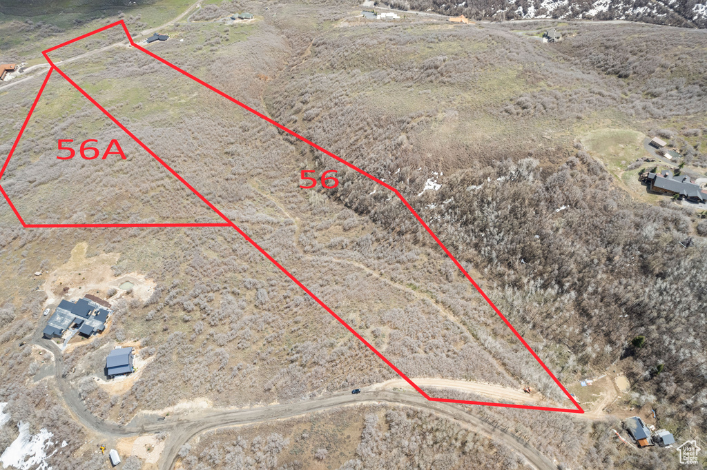 Birds eye view of property with view of desert and a rural view