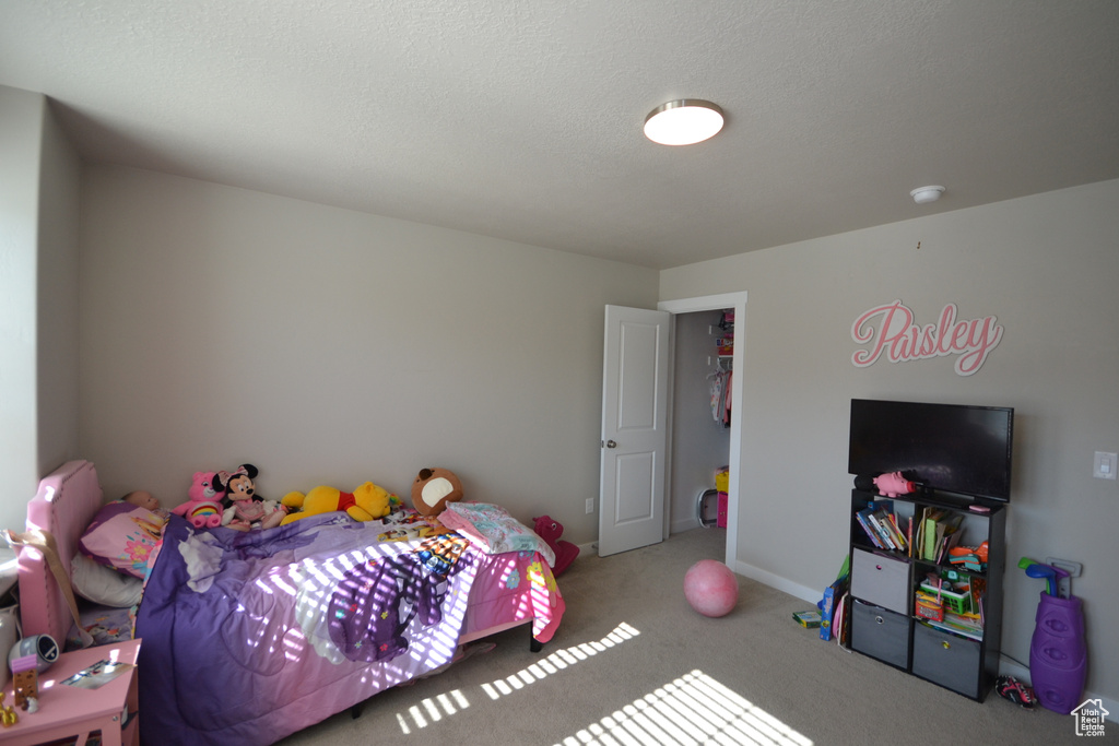 Bedroom featuring carpet and baseboards