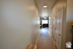 Hallway featuring baseboards and wood finished floors