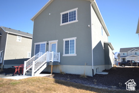 Back of house featuring stucco siding