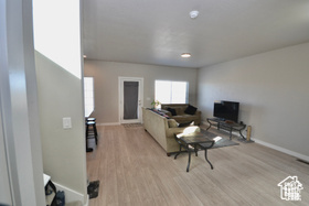 Living area with baseboards and light wood-style flooring