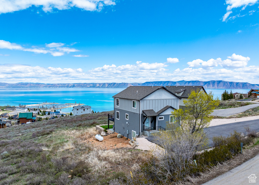 Drone / aerial view with a water and mountain view