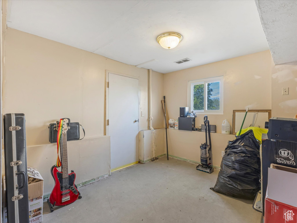 Miscellaneous room featuring visible vents and concrete floors