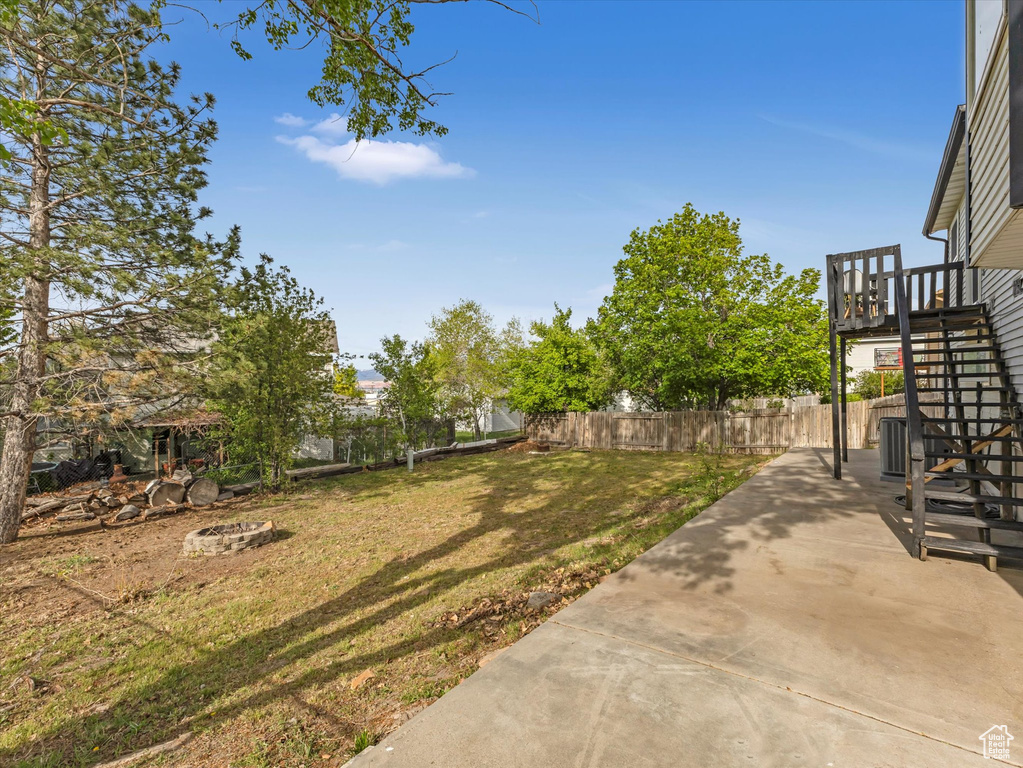 View of yard featuring a patio, a fenced backyard, and stairway