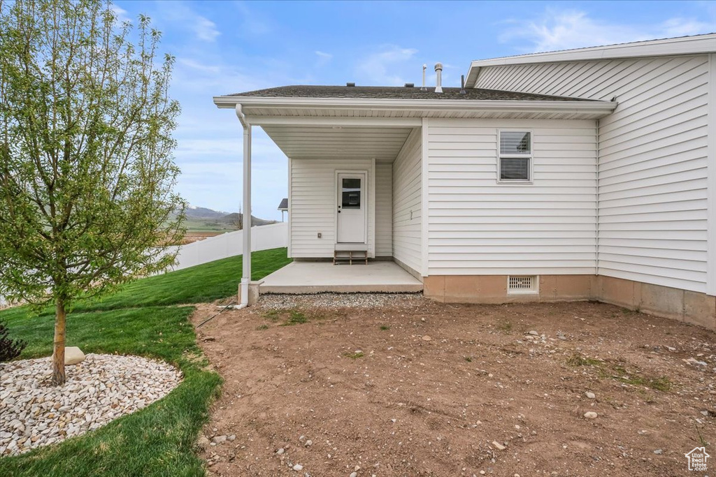 Back of house featuring fence and a lawn