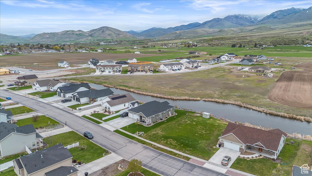 Drone / aerial view with a water and mountain view and a residential view