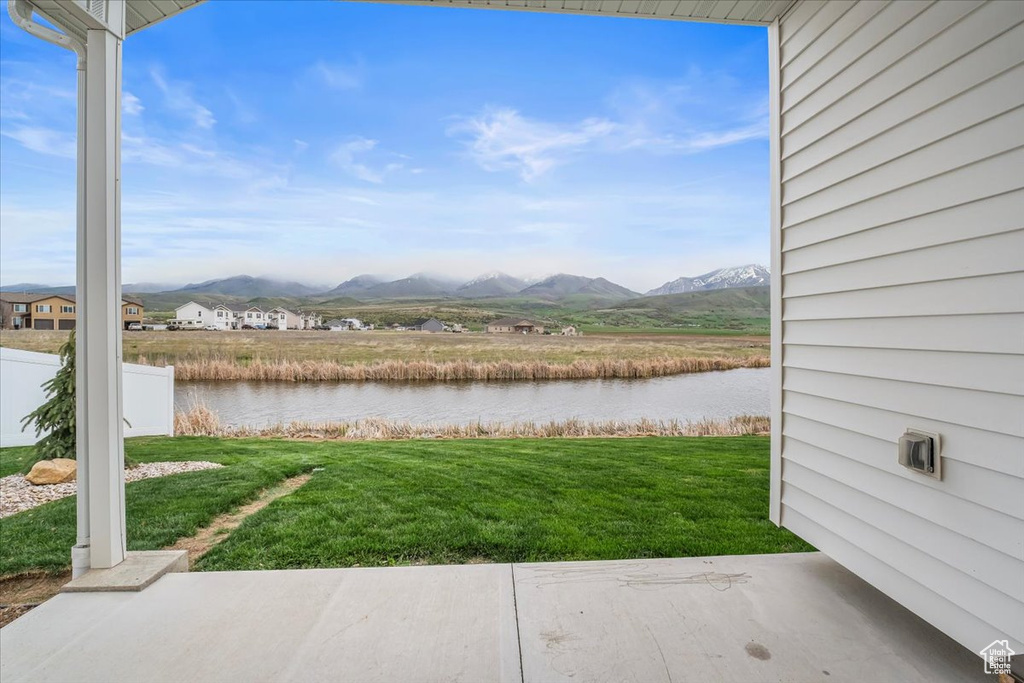 View of yard featuring fence and a water and mountain view