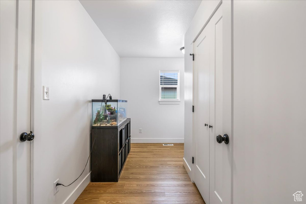 Corridor featuring baseboards and light wood-type flooring