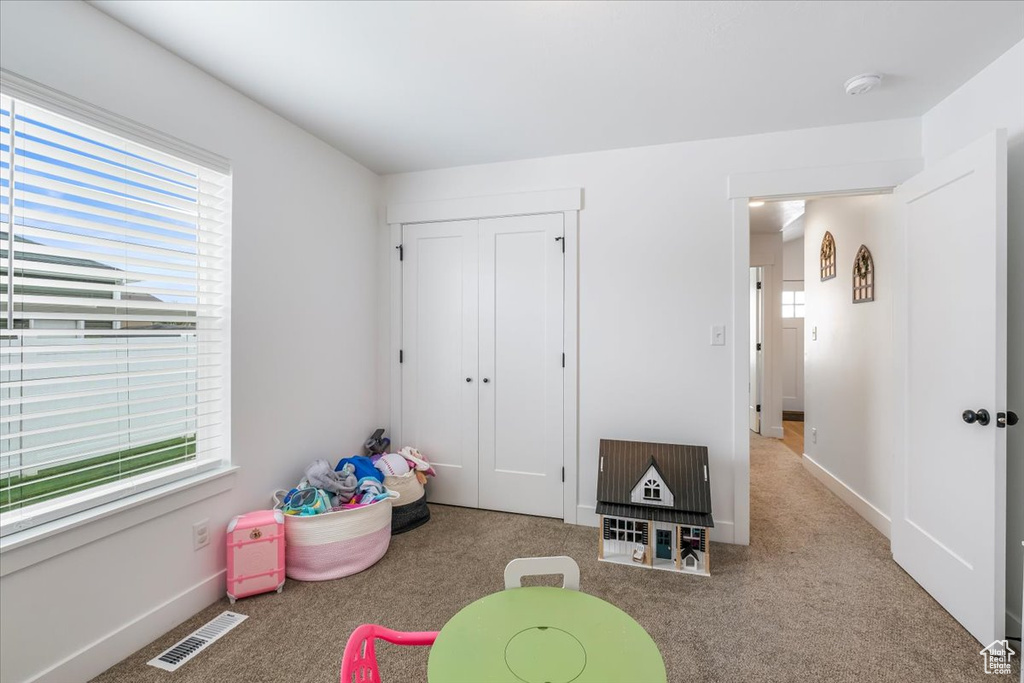 Game room with visible vents and carpet flooring