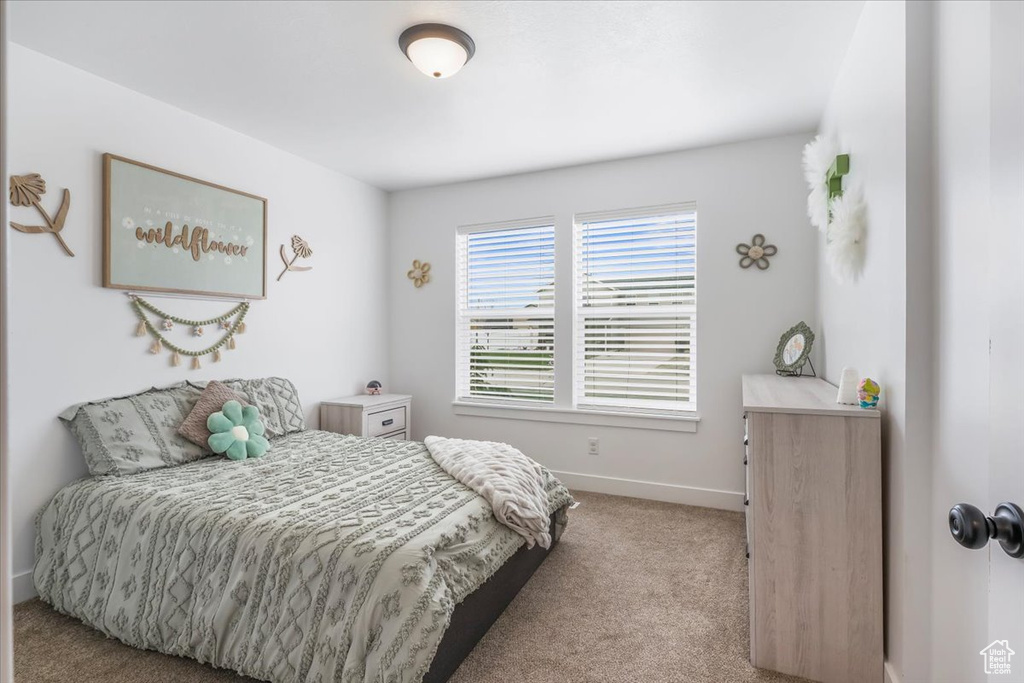 Bedroom featuring baseboards and carpet