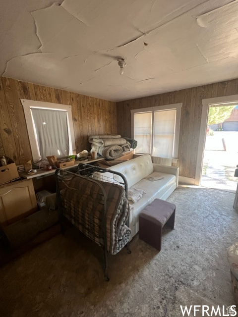 Bedroom featuring wood walls