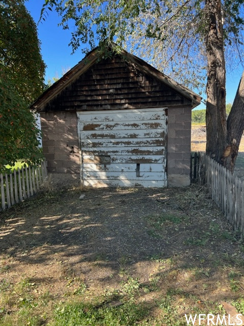 View of outbuilding featuring fence and an outdoor structure