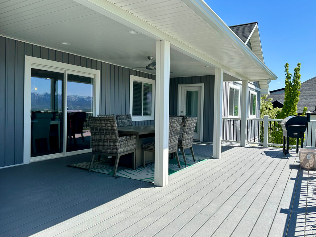 Deck featuring ceiling fan and a grill