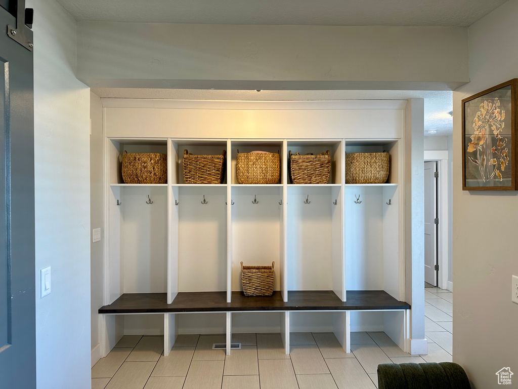 Mudroom with light tile patterned floors and visible vents