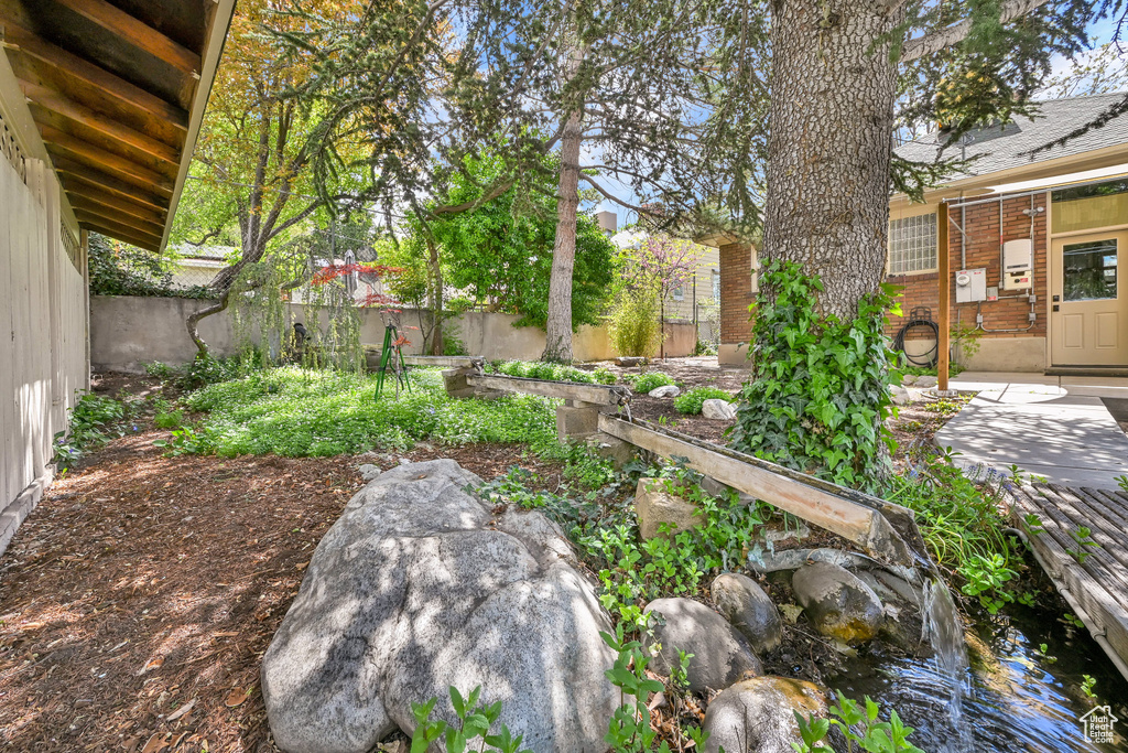 View of yard with a fenced backyard, a patio area, and a vegetable garden