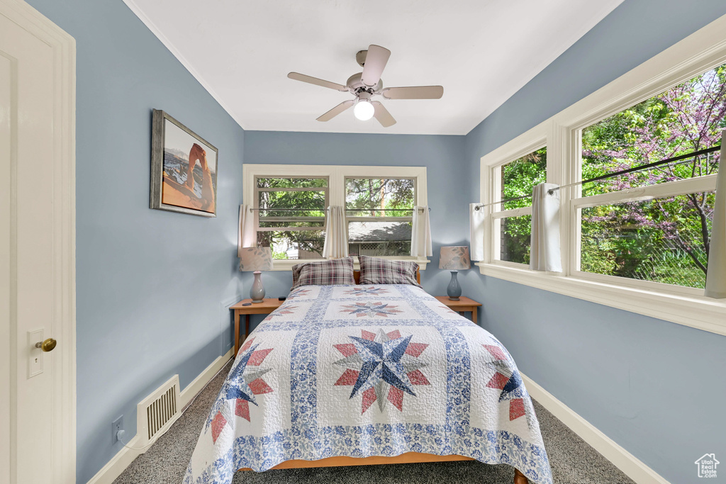 Bedroom featuring baseboards, a ceiling fan, carpet flooring, and visible vents