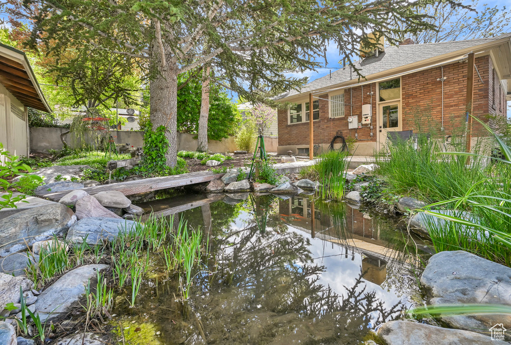 Exterior space with fence and a garden pond