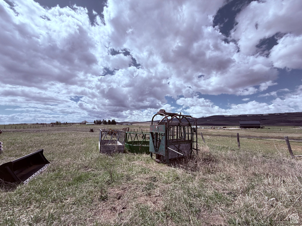 View of yard featuring fence and a rural view