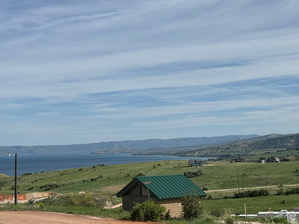 Property view of mountains featuring a water view
