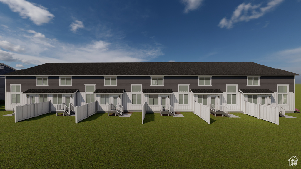 Rear view of property with a yard