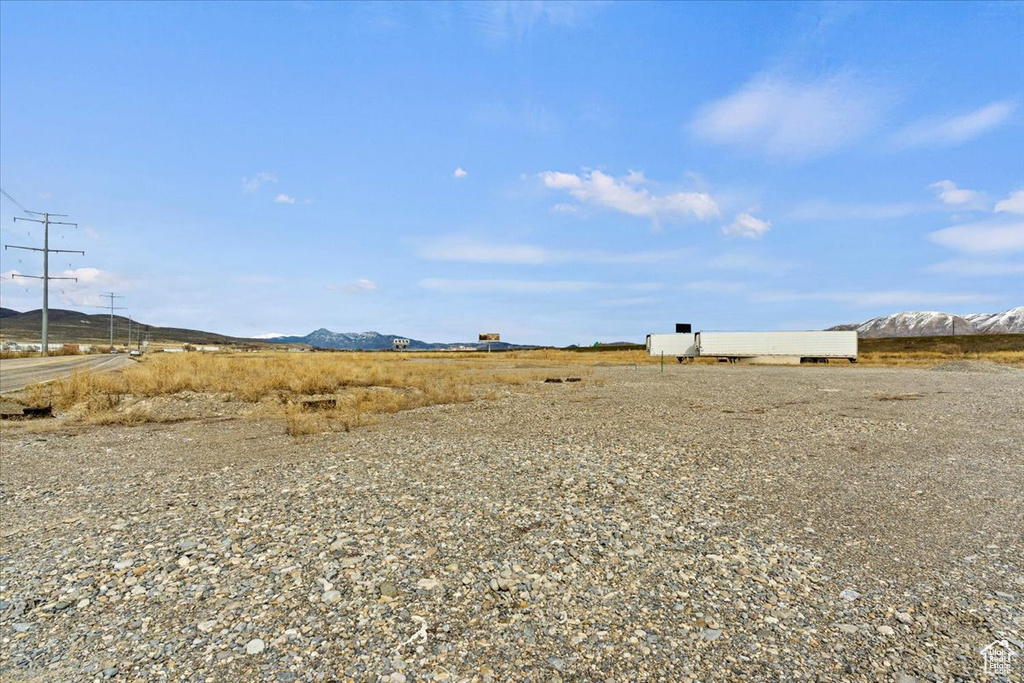 View of yard featuring a rural view and a mountain view
